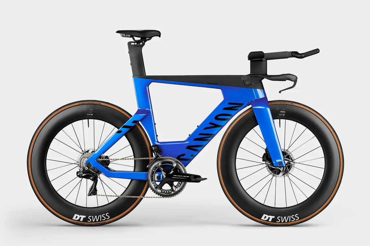 Blue Canyon Speedmax CFR triathlon bike with aero extensions on the handlebar and deep carbon wheels