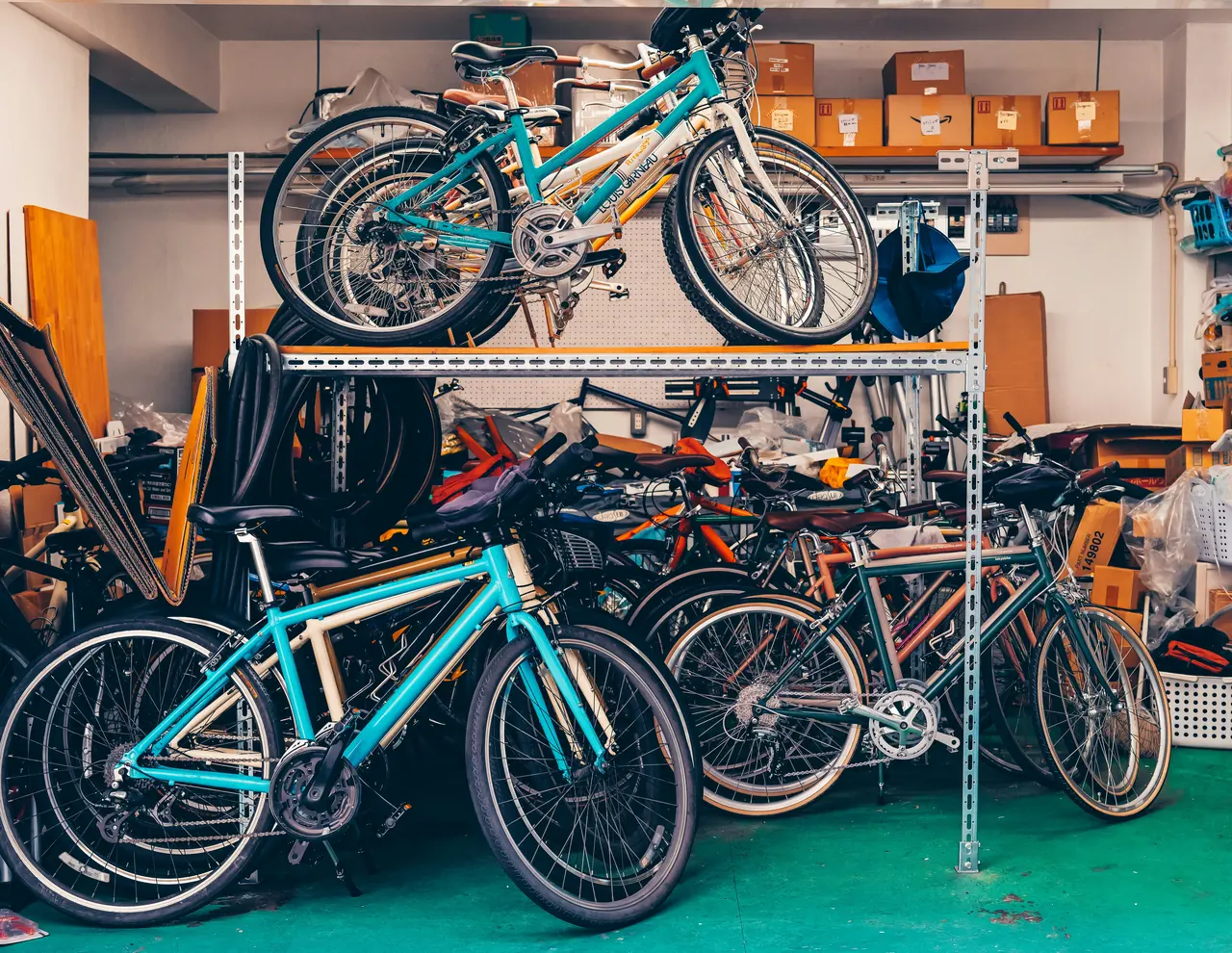 A storage room full of bicycles of different types, sizes and colours