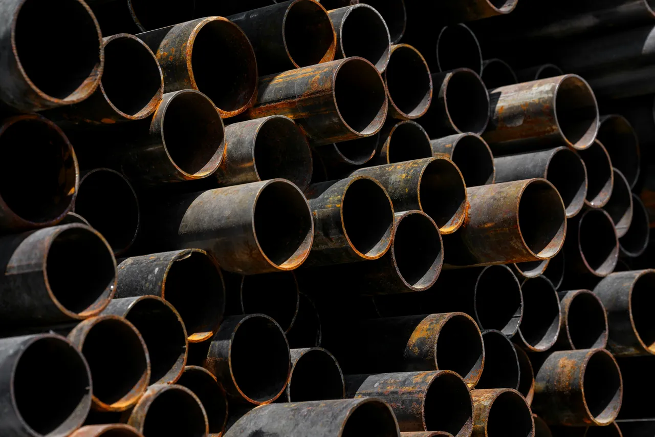 Stack of rusty steel pipes seen end-on