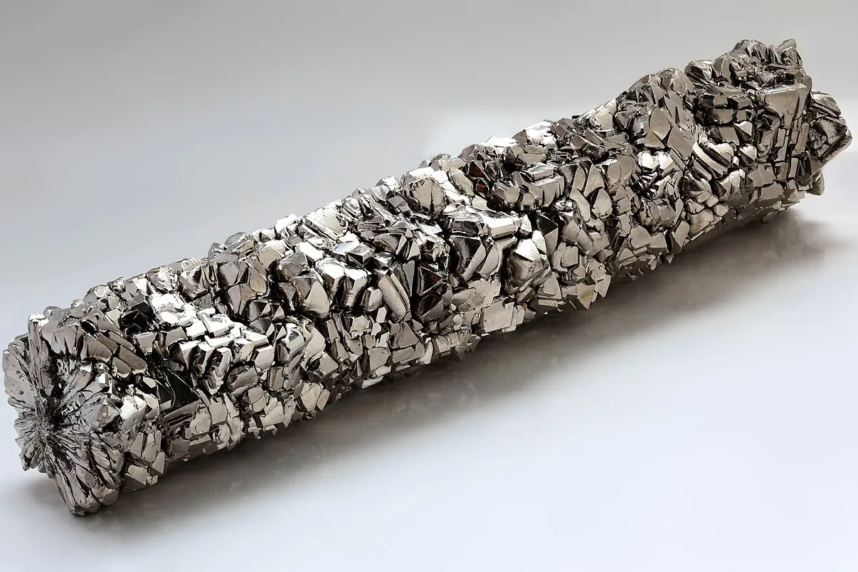 A bar of high-purity titanium crystals on a light background